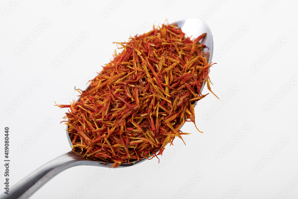 Fototapeta premium Silver teaspoon with saffron on white background
