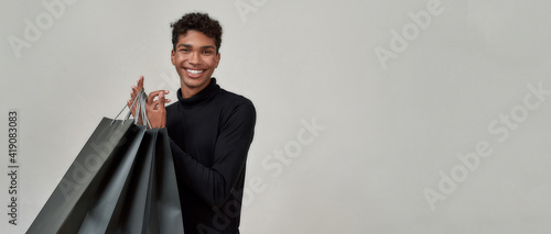 Happy young african american man with shopping bags
