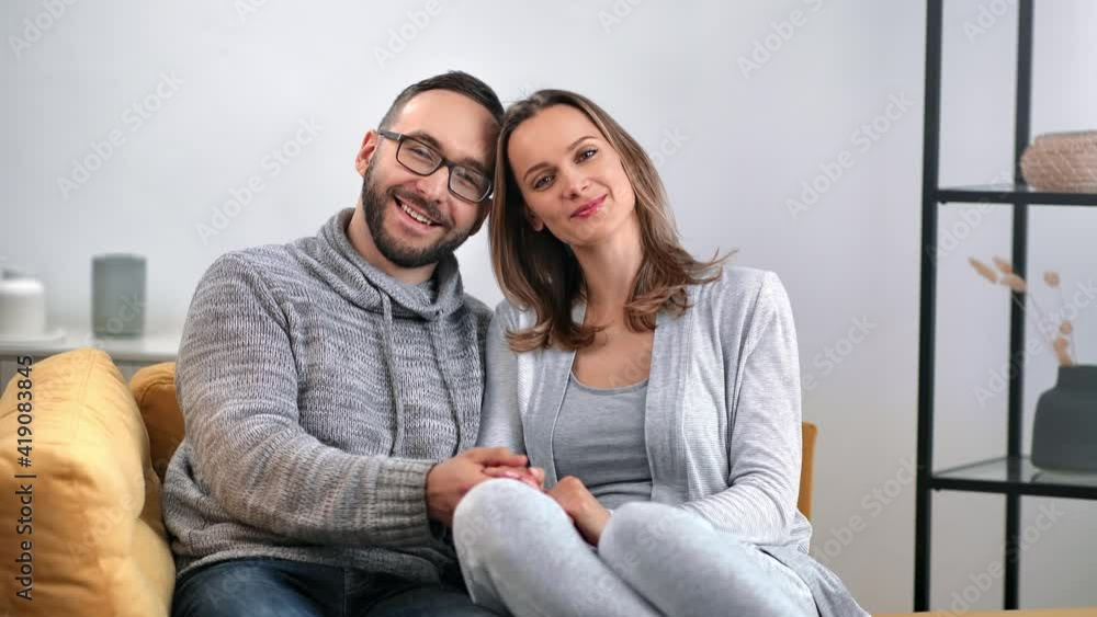 Happy enamored couple hugging posing together on couch having positive emotion. 4k Dragon RED camera Happy enamored couple hugging posing together on couch having positive emotion. 4k Dragon RED camera