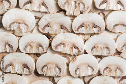 Young mushrooms champignons, sliced into plates, close-up, background