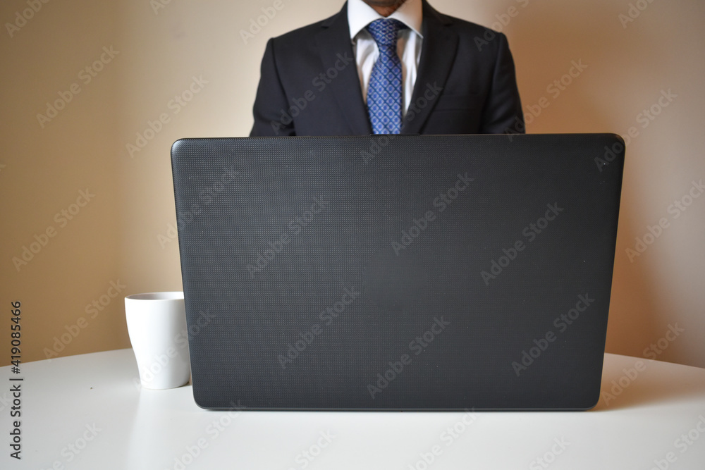 businessman wearing a suit and working with a portatail from home businessman wearing a suit and working with a portatail from home