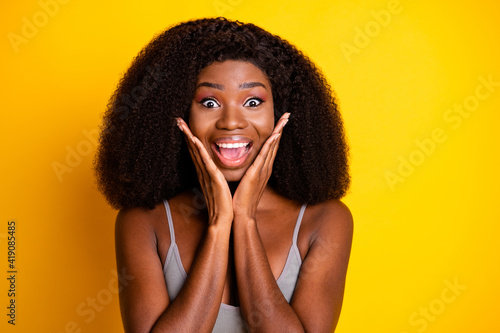 Photo of excited crazy lady hands cheekbones open mouth wear singlet isolated yellow color background