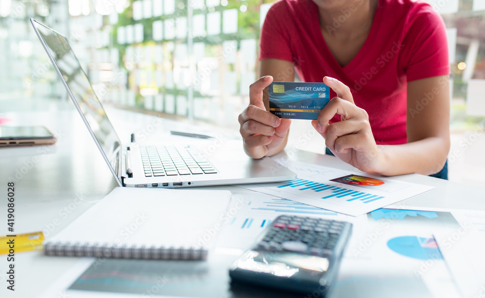 Fototapeta premium Close up of Hands holding credit card and using laptop for Online shopping