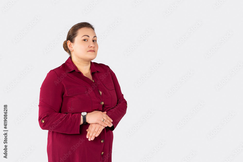 Beautiful plus size, serious young overwight woman wearing formal dress isolated grey background smiling looking to camera with hands crossed, convinced and confident Beautiful plus size, serious young overwight woman wearing formal dress isolated grey background smiling looking to camera with hands crossed, convinced and confident