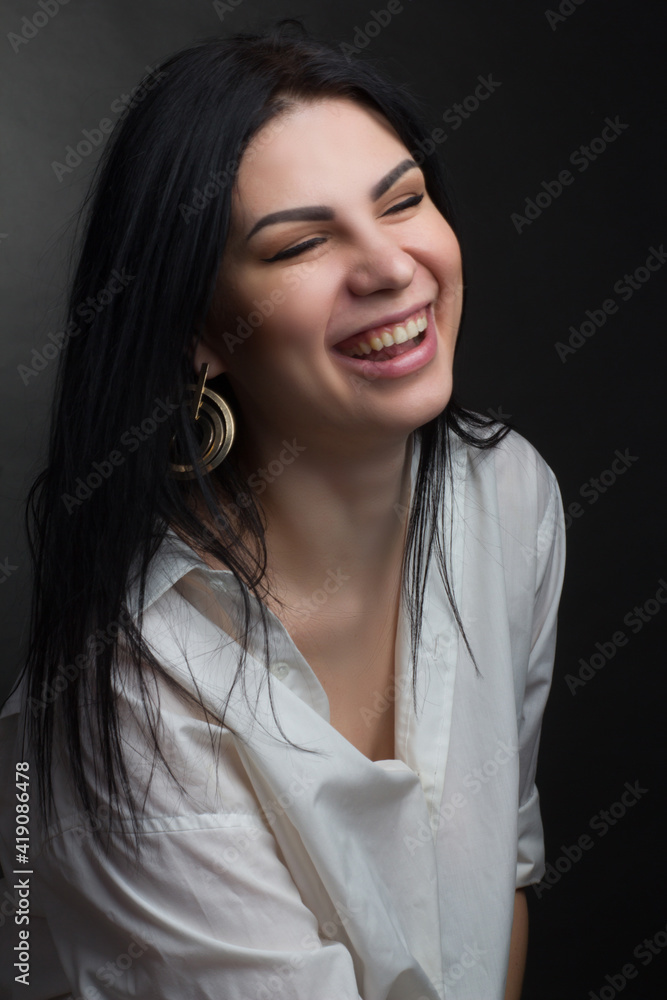 Fototapeta premium Studio portrait of a brunette in white T-shirt