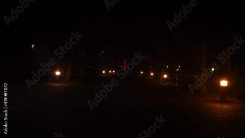 Red orange lanterns next to walkway at night