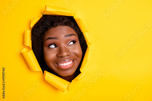 Photo of dreamy inspired woman look up empty space shiny white smile through bright yellow color background © deagreez