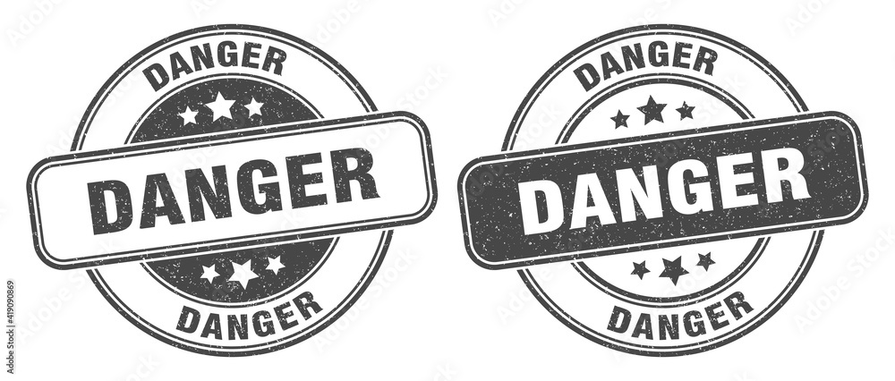 Obraz premium danger stamp. danger label. round grunge sign