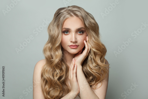 Cute young woman with long healthy perfect hair on white background