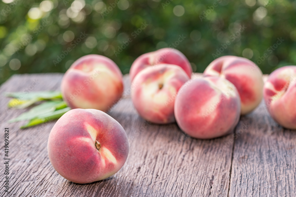 Fresh Peach fruits on wooden table in blur background, Peach on wooden table in garden. Fresh Peach fruits on wooden table in blur background, Peach on wooden table in garden.