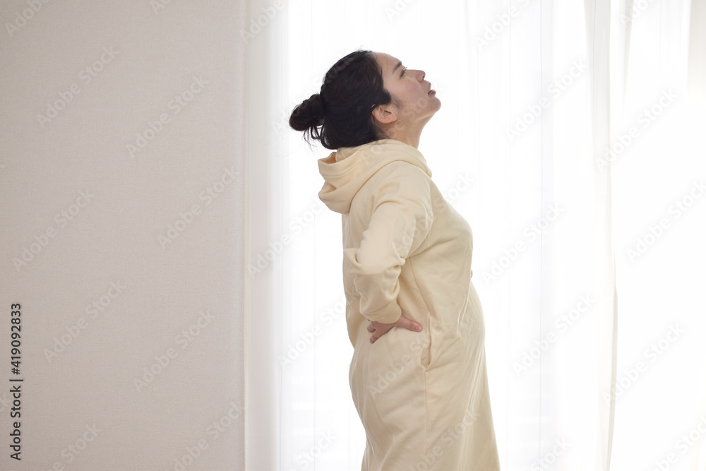 A young pregnant woman is suffering from back pain. My back tends to hurt during pregnancy. A young pregnant woman is suffering from back pain. My back tends to hurt during pregnancy.