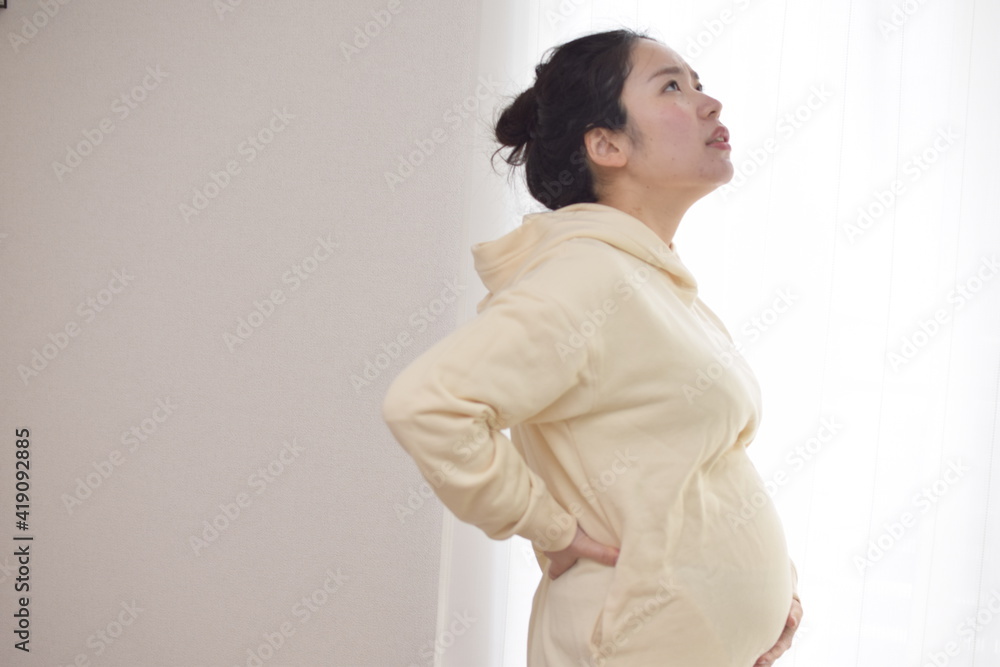 A young pregnant woman is suffering from back pain. My back tends to hurt during pregnancy. A young pregnant woman is suffering from back pain. My back tends to hurt during pregnancy.
