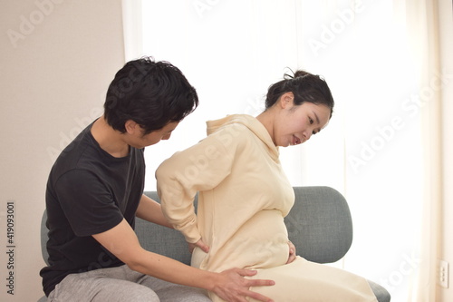 My husband is worried about a young pregnant woman suffering from back pain.