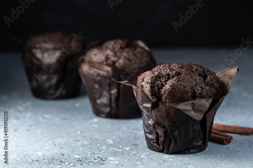 Chocolate muffins with crispy top. Selective focus. Copy space.