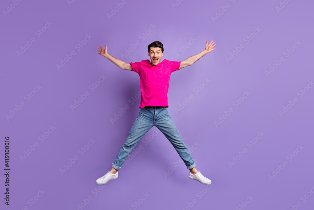 Full body portrait of cheerful impressed guy raise hands make star figure open mouth isolated on purple color background Full body portrait of cheerful impressed guy raise hands make star figure open mouth isolated on purple color background
