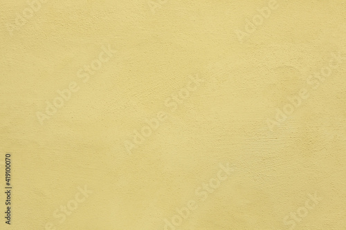 Yellow painted stucco wall. Background texture