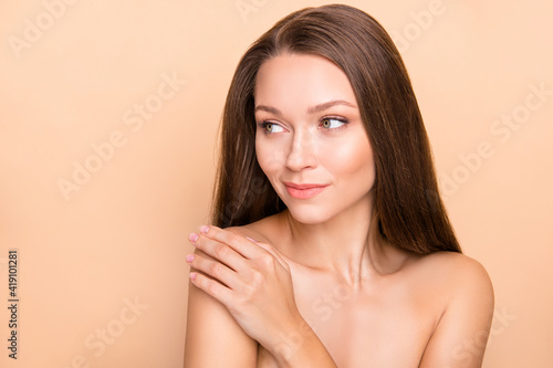 Photo of young attractive girl apply body lotion hydration moisturizing look empty space isolated over beige color background