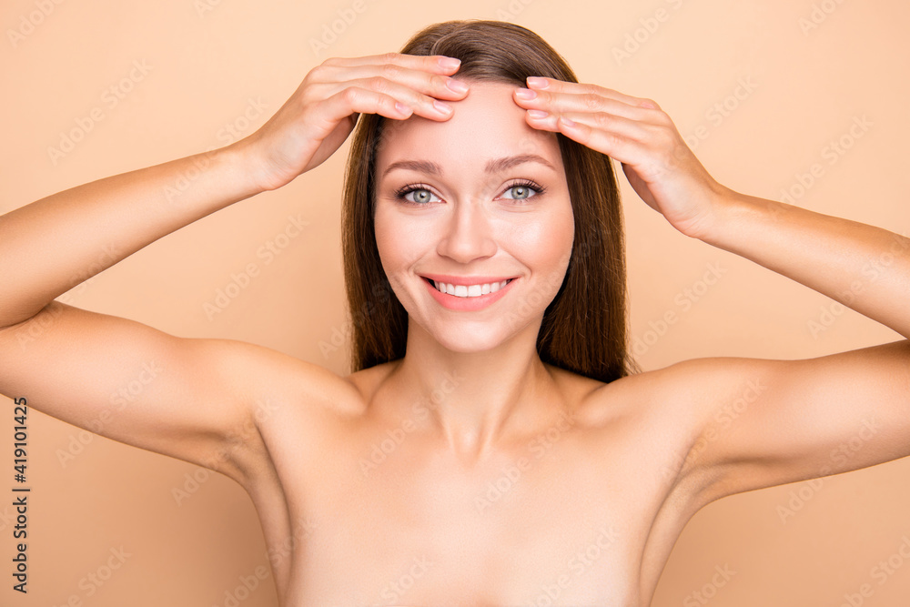 Fototapeta premium Photo of pretty cheerful lady hands fingers touch forehead no clothing isolated on beige color background