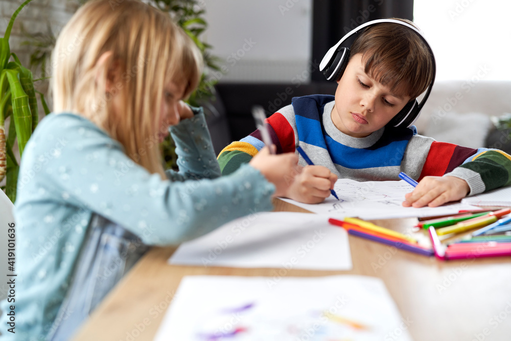 Fototapeta premium Brother and sister doing homework together