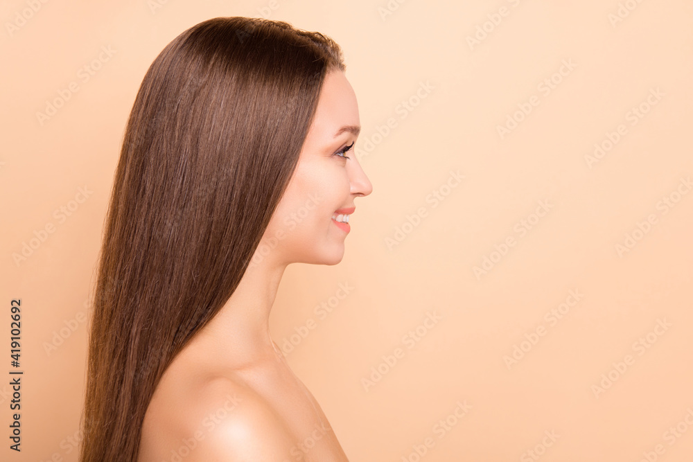 Profile portrait of positive adorable person look empty space no clothing isolated on beige color background Profile portrait of positive adorable person look empty space no clothing isolated on beige color background