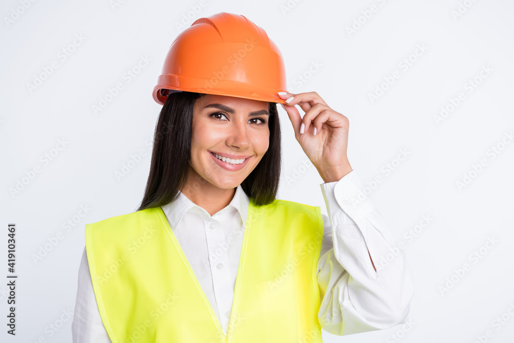 Photo of cheerful builder lady look camera beaming shiny smile wear helmet shirt vest isolated white color background Photo of cheerful builder lady look camera beaming shiny smile wear helmet shirt vest isolated white color background