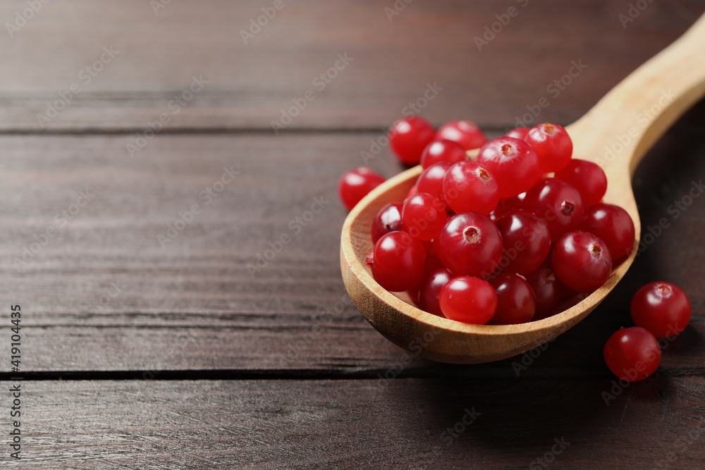 Fresh cranberry on wooden table, space for text Fresh cranberry on wooden table, space for text
