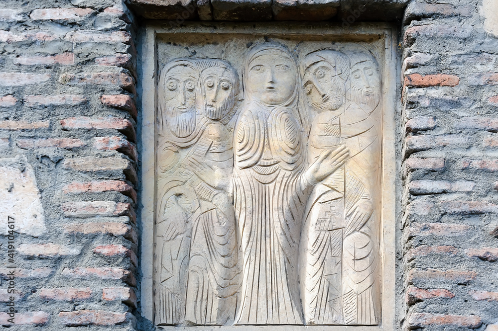 Wooden relief on a brick fence in Tbilisi Georgia Wooden relief on a brick fence in Tbilisi Georgia