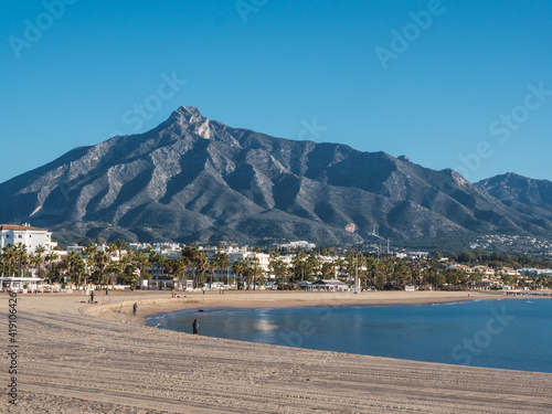 Beach of Puerto Banus with the mountains of Sierra Blanca at background, Marbella, Costa del Sol, Malaga province, Spain