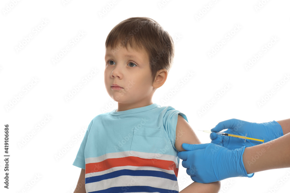 Doctor vaccinating little boy on white background