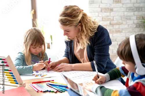 Photos Mom helping her kids with homeschooling during the lockdown