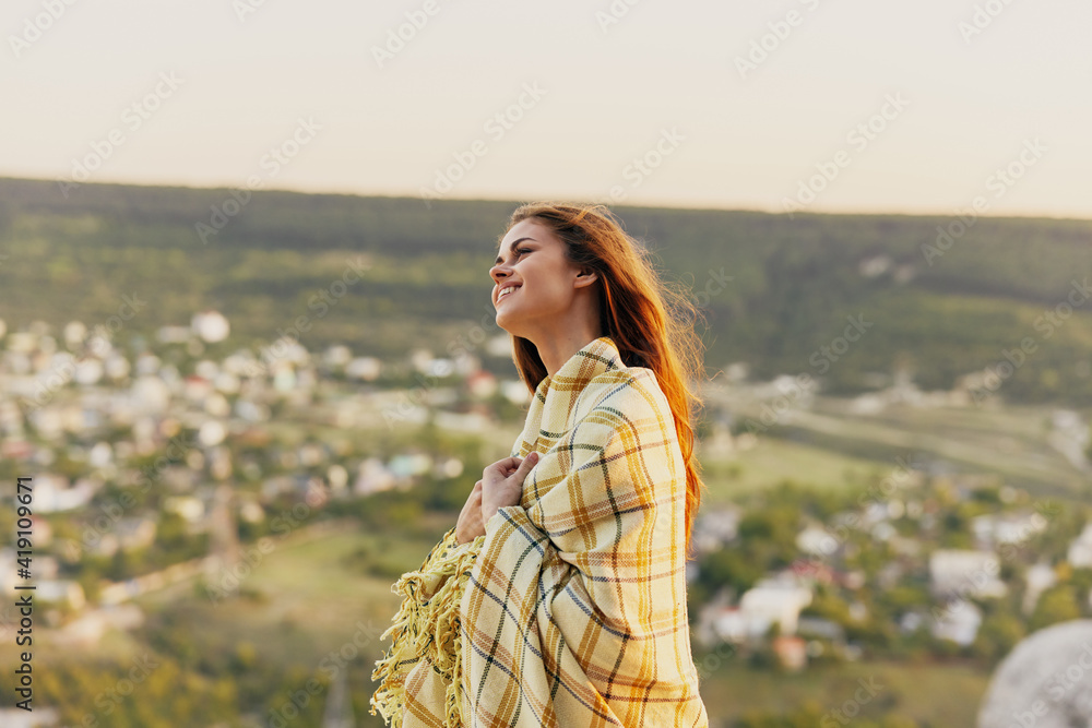 Romantic woman with a plaid in nature and the village in the background fresh air Romantic woman with a plaid in nature and the village in the background fresh air
