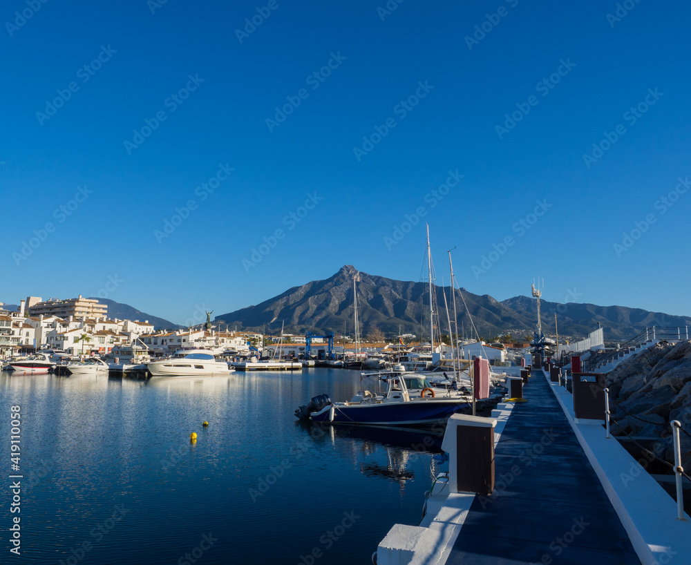 Puerto Banus with the mountains of Sierra Blanca at background, Marbella, Costa del Sol, Malaga province, Spain