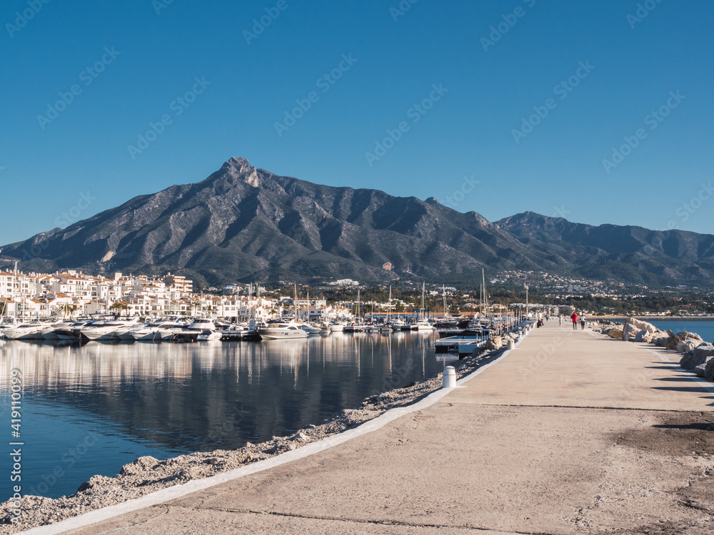 Puerto Banus with the mountains of Sierra Blanca at background, Marbella, Costa del Sol, Malaga province, Spain Puerto Banus with the mountains of Sierra Blanca at background, Marbella, Costa del Sol, Malaga province, Spain