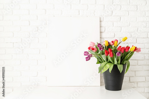 Mock up with Frame and bucket of tulips on white brick wall background