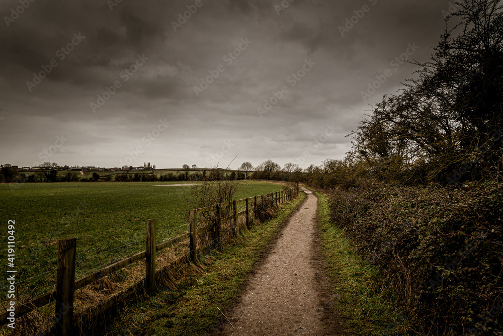 Long path under stormy sky