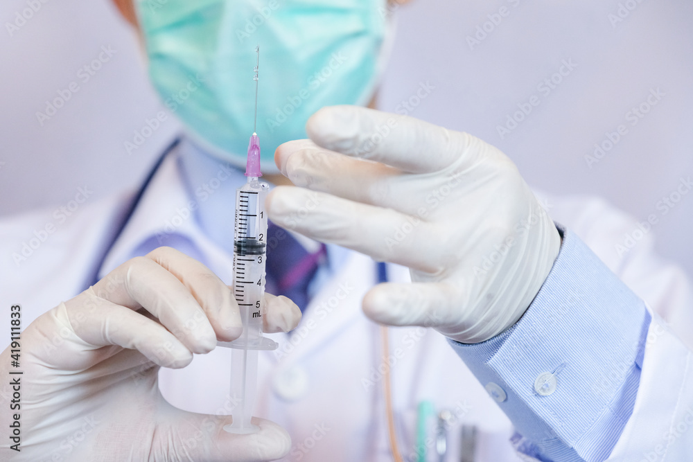 Medicine doctor holding flu, measles, coronavirus vaccine. Vaccination Vaccine Syringe Injection Prevention Immunization Treatment Coronavirus Covid 19 Infectious. Medicine doctor holding flu, measles, coronavirus vaccine. Vaccination Vaccine Syringe Injection Prevention Immunization Treatment Coronavirus Covid 19 Infectious.