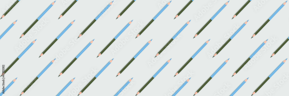 Banner with color pencils pattern on a blue pastel background. Creative concept. Banner with color pencils pattern on a blue pastel background. Creative concept.