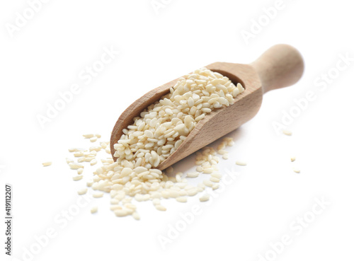 Wooden scoop with sesame seeds on white background