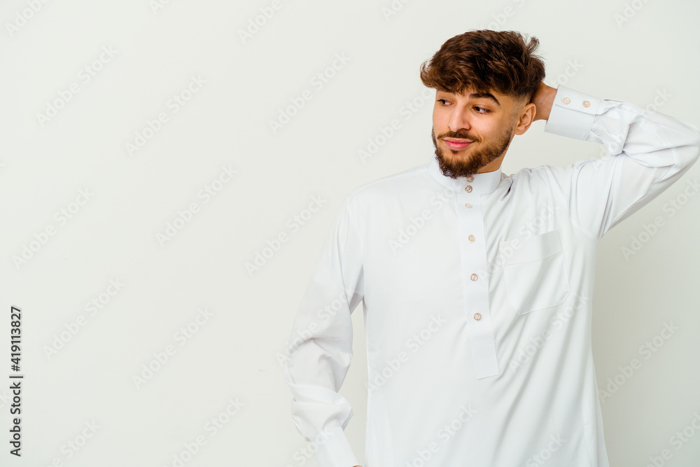 Young Moroccan man wearing a typical arab clothes isolated on white background touching back of head, thinking and making a choice. Young Moroccan man wearing a typical arab clothes isolated on white background touching back of head, thinking and making a choice.