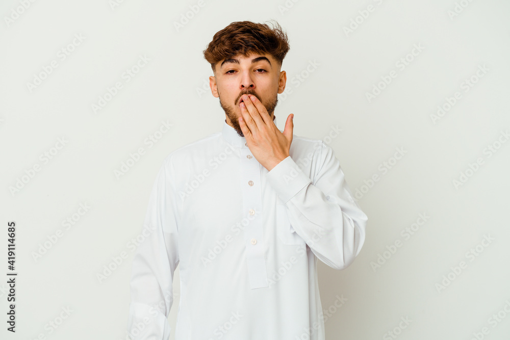 Young Moroccan man wearing a typical arab clothes isolated on white background yawning showing a tired gesture covering mouth with hand. Young Moroccan man wearing a typical arab clothes isolated on white background yawning showing a tired gesture covering mouth with hand.