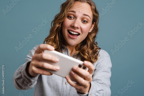 Close up portrait of a happy young woman playing games