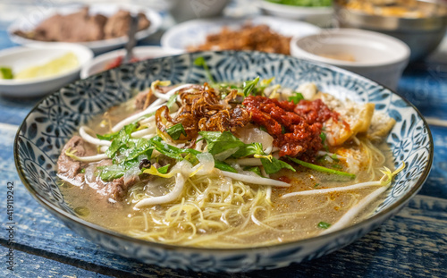 Malaysian soup noodles or locally know as Bihun Sup Utara with ingredients. Selective focus.