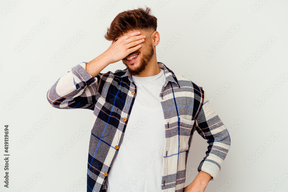 Young Moroccan man isolated on white background laughs joyfully keeping hands on head. Happiness concept. Young Moroccan man isolated on white background laughs joyfully keeping hands on head. Happiness concept.