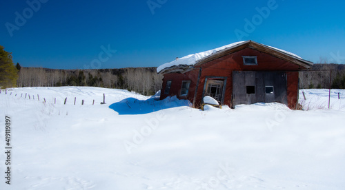 Very old garage in a field during Quebec winter in Canada
