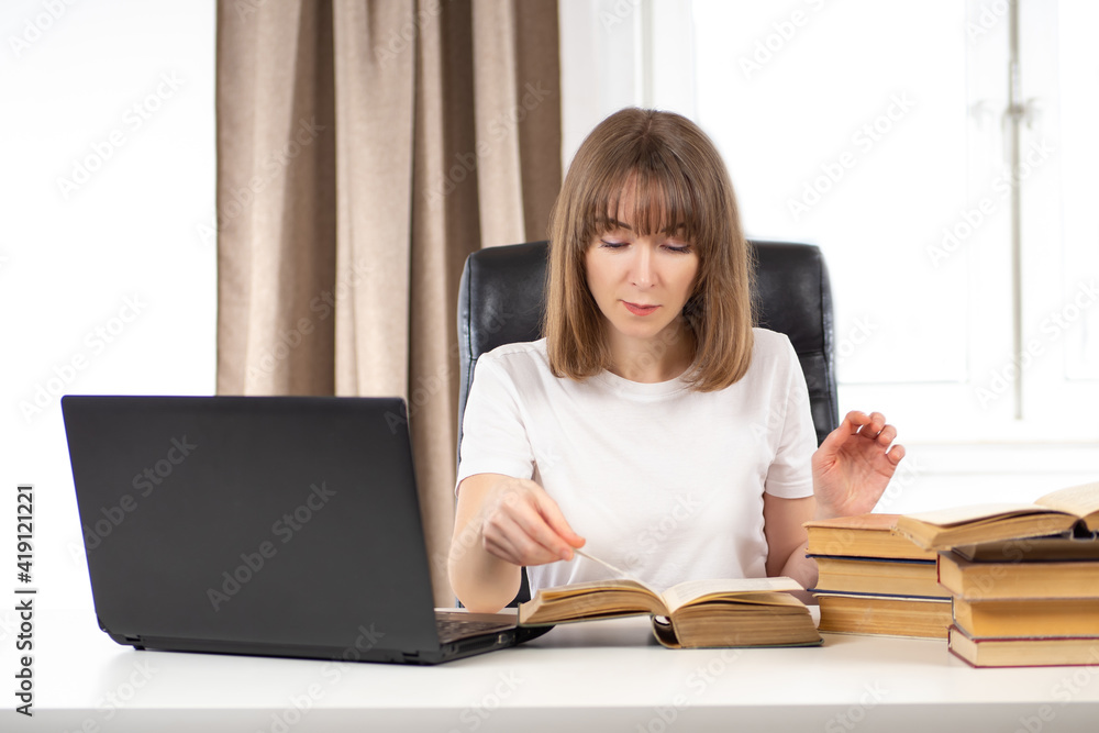 Woman researching something. Girl student with many textbooks on table. She is educated on her own. Woman is doing some research. Concept - journalist research through reading books. Woman researching something. Girl student with many textbooks on table. She is educated on her own. Woman is doing some research. Concept - journalist research through reading books.