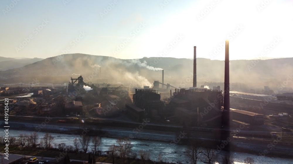 Aerial drone view of heavy industrial air pollution from smokestacks. Factory chimney blowing pollution in environment. Smoking pipes. Toxic smoke in industrial area. Aerial drone view of heavy industrial air pollution from smokestacks. Factory chimney blowing pollution in environment. Smoking pipes. Toxic smoke in industrial area.