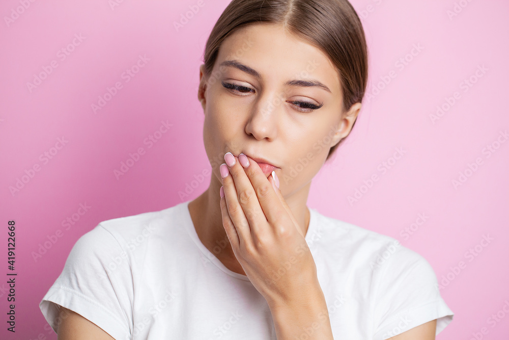 Portrait of a beautiful young woman experiencing a painful toothache Portrait of a beautiful young woman experiencing a painful toothache
