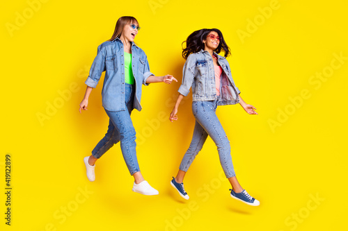 Full size profile photo of carefree attractive persons have fun good mood isolated on yellow color background
