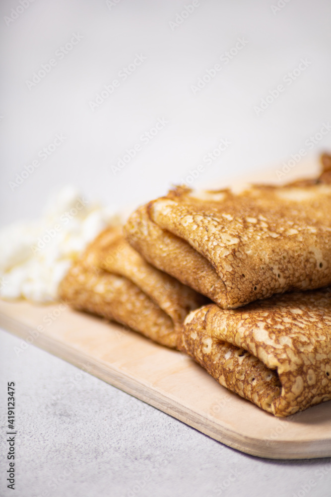 Pancakes roll on a light background close-up