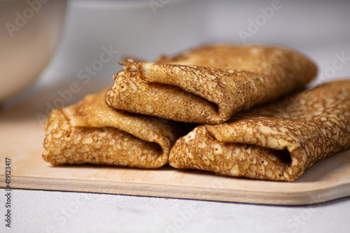 Pancakes roll on a light background close-up